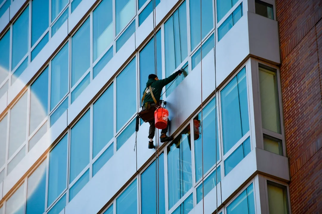 hero-img Urban worker cleaning windows on a high-rise in Ho Chi Minh City, Vietnam.